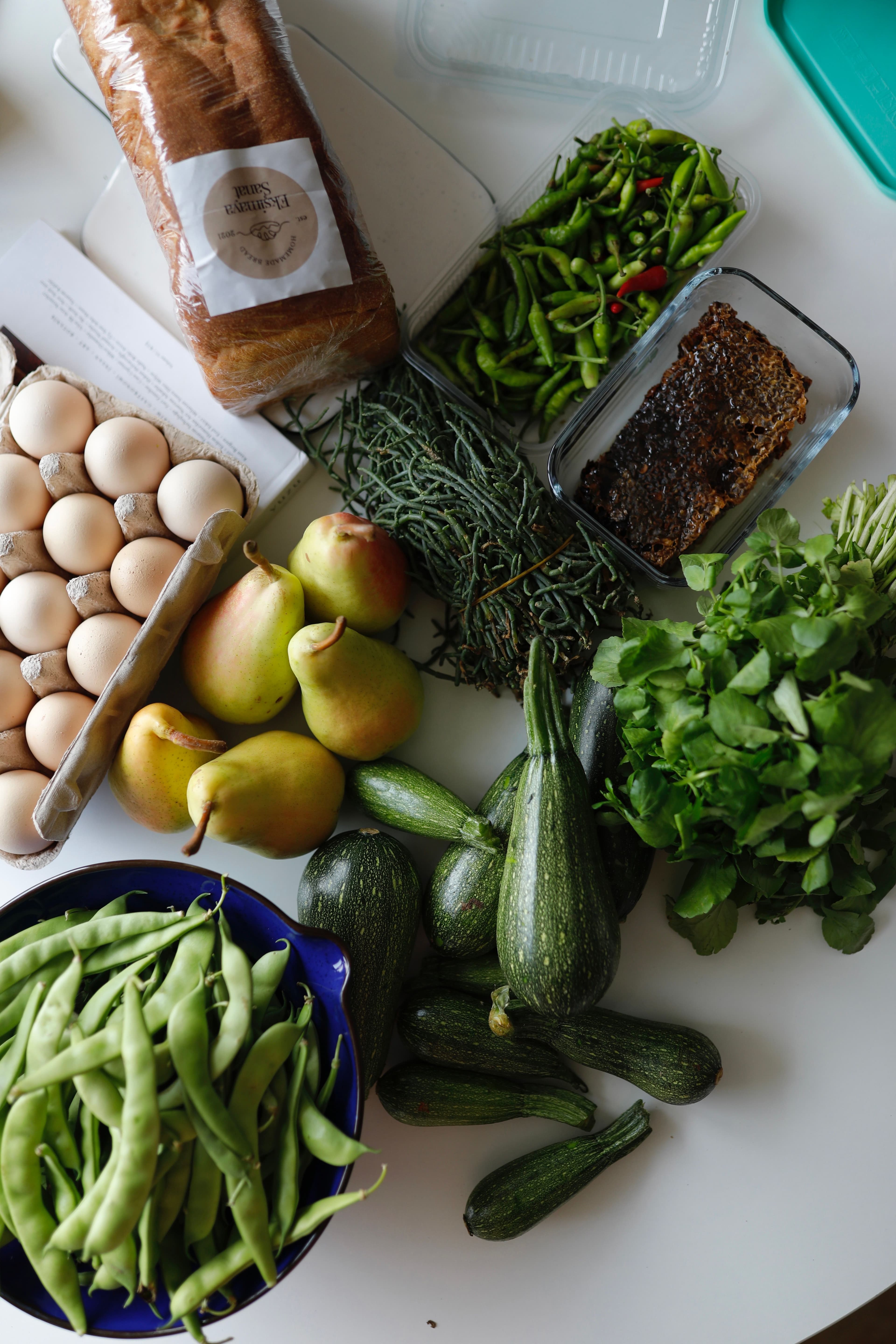 Fresh groceries laid out — eggs, vegetables, and more