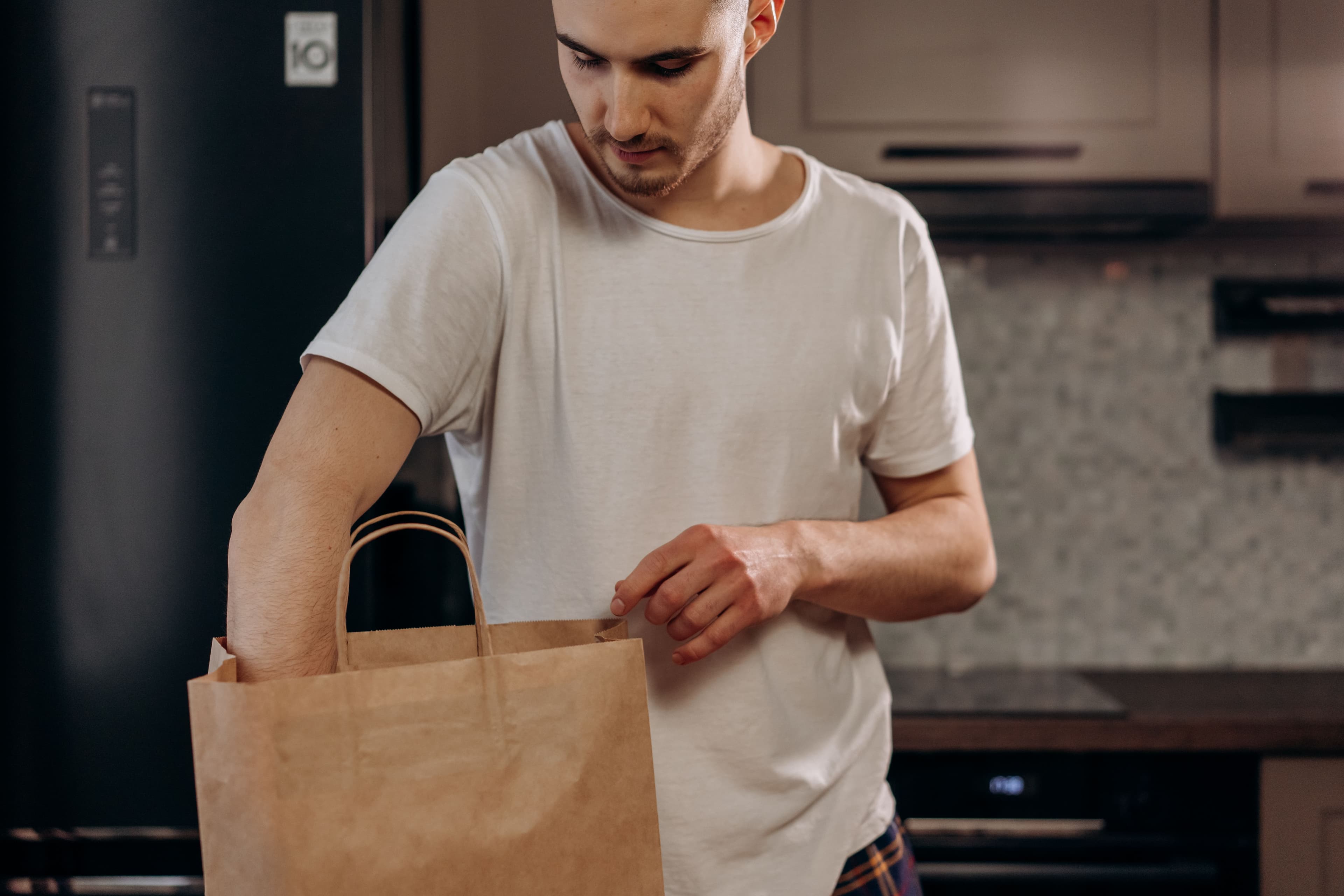 Unpacking groceries from a shopping bag